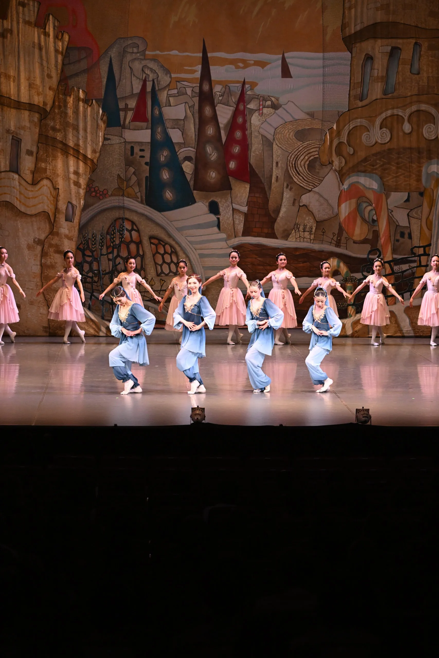 Ligne de danseuses en bleu et rose, en formation.